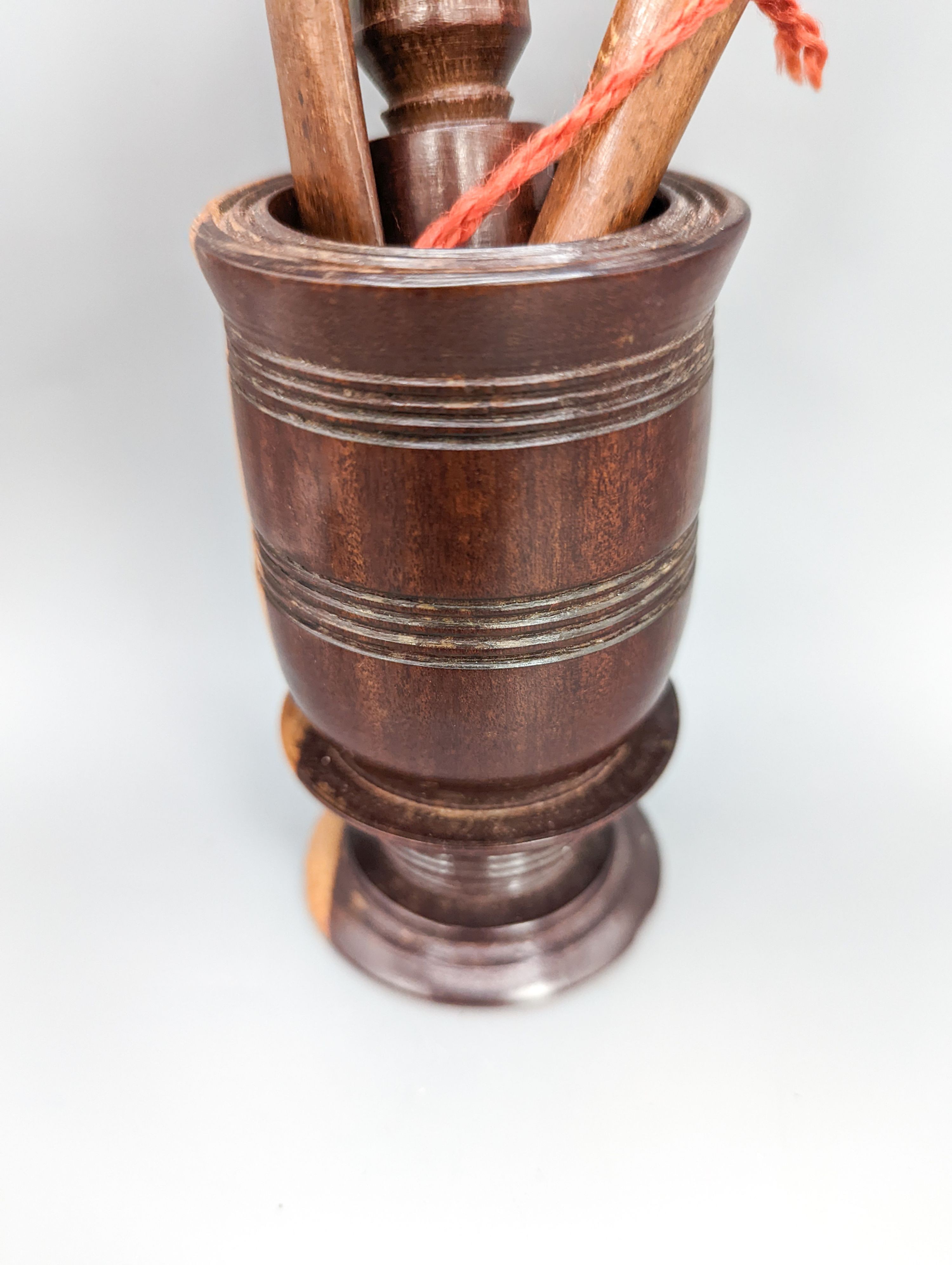 A 19th century lignum vitae pestle and mortar, 10.5cm, a pair of treen butter spoons and an agate mounted brass pillbox